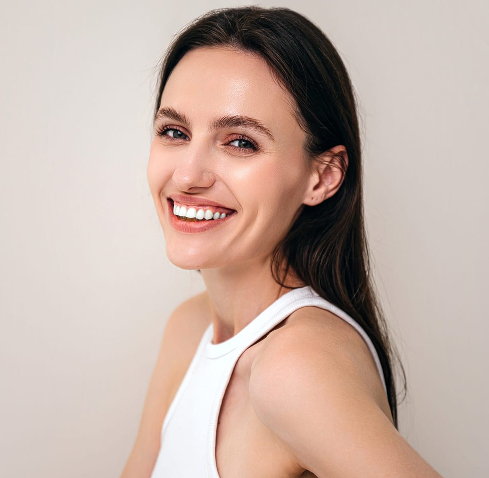Woman laughing and looking at camera